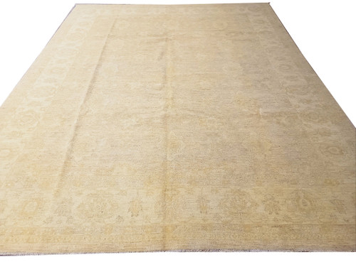 8'7" x 11'7" Chobi Peshawar rug angled on white, pale beige field with floral border