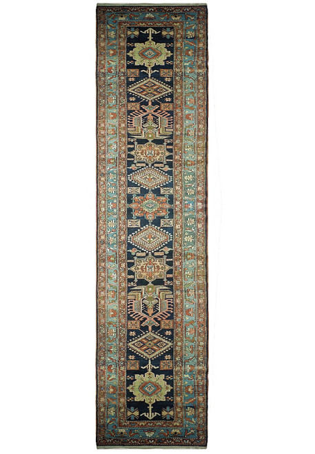 Navy blue Persian Heriz Karaja runner with rust, sage and ivory medallions viewed flat overhead