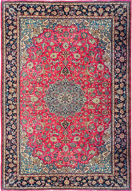 Red field Persian Isfahan rug with navy border and layered blue floral medallion in wool