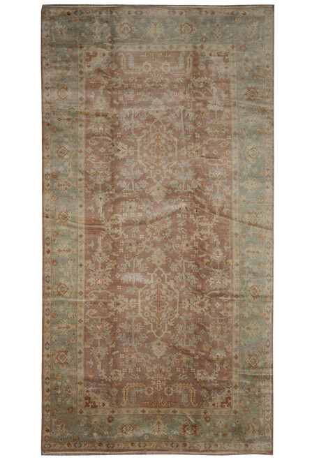 Full view of 8'4" x 15'7" Oushak design rug with rust field and sage green border