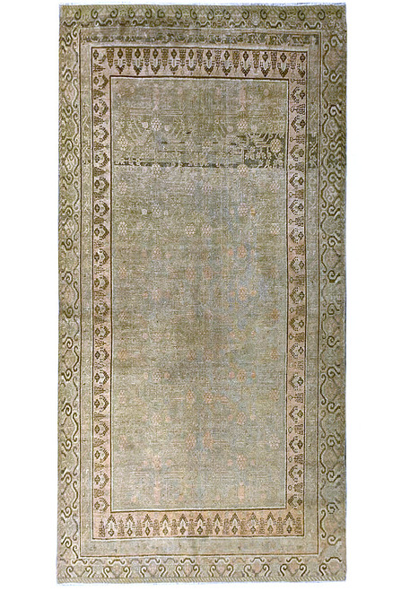 Full view of sage green Oushak rug with peach rosettes, cloud band border and ivory guard stripes