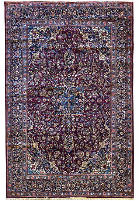 Full overhead view of a burgundy and navy Persian Kashan rug with dense floral field