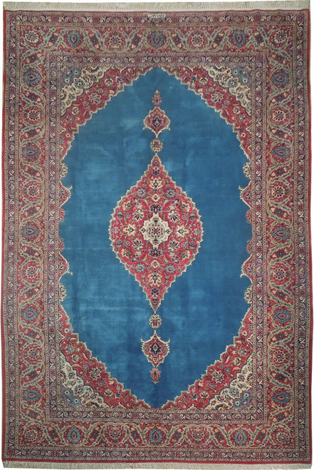 Turquoise blue field with red floral medallion and ivory spandrels on Persian Kashan rug
