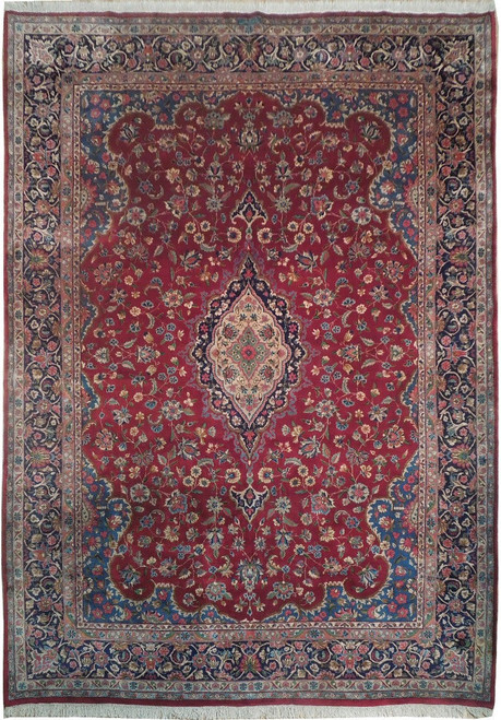 Red and navy Persian rug with ivory pointed medallion and dense all-over floral field