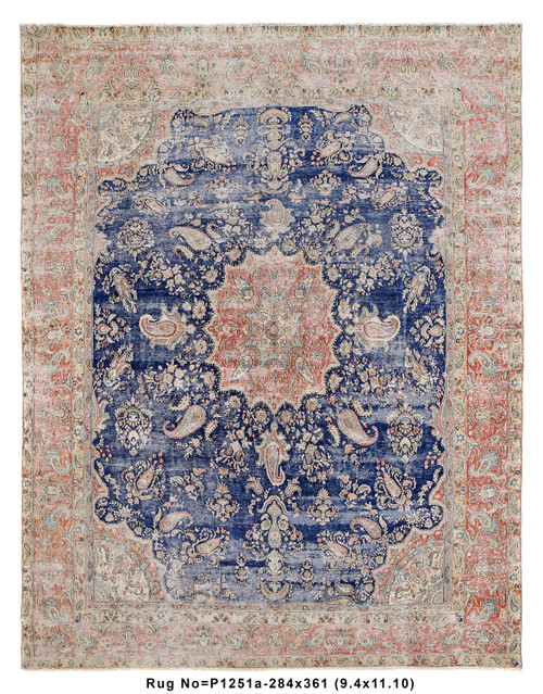 Full overhead view of vintage Persian Kerman rug with faded blue field and coral paisley border