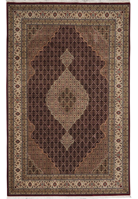 Full view of 6'6" x 9'10" Tabriz Mahi rug with ivory medallion on ruby burgundy field