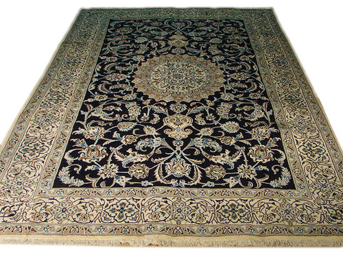 Black field Persian Nain rug with ivory floral border and central domed medallion shown flat