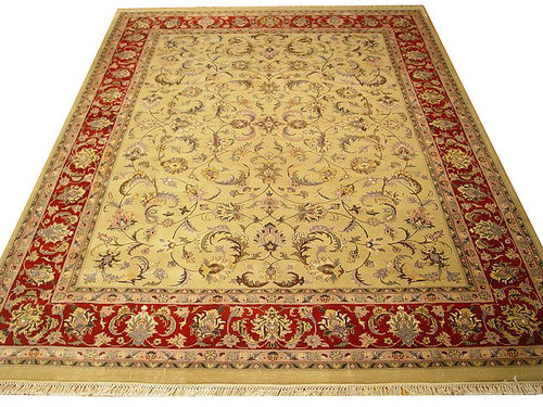 Full view of beige and red hand-knotted Indian rug with all-over floral vine design