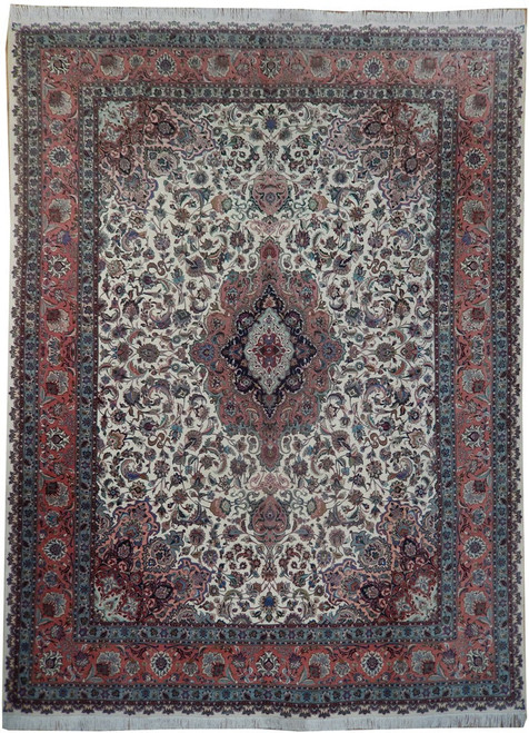 Ivory field Persian Tabriz rug with coral floral border and navy center medallion, full view