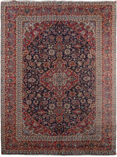 Full overhead view of the navy Kashan rug with central red medallion and wide floral border