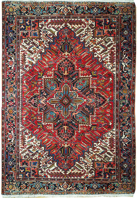 Overhead full view of the 8'4" x 10' red Persian Heriz rug with navy star medallion