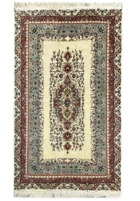 Full view of 5'1 x 8'10 Persian Kerman rug with ivory field and seafoam border
