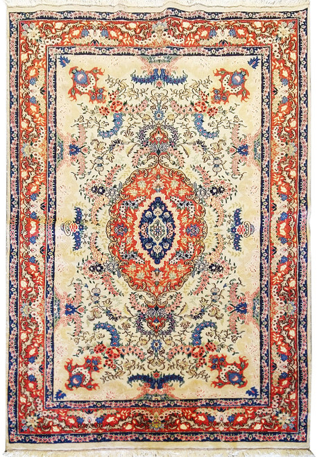 Full overhead view of ivory Persian Tabriz rug with coral medallion and navy floral border