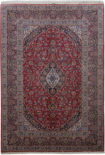 8'3" x 12'2" Persian Kashan rug with red field, navy medallion and ivory floral spandrels