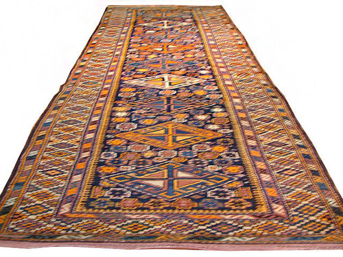 Full view of 3'5" x 13'2" Kazak design runner rug with navy field and multicolor medallions