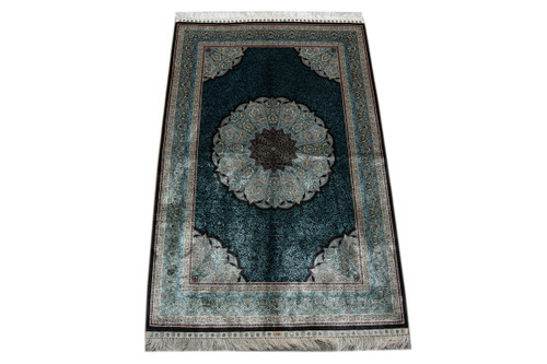 Full view of 4'6" x 6'9" turquoise and black silk rug with round floral medallion