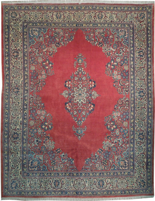 Antique red Persian Kerman rug with ivory floral border and navy diamond medallion, full overhead view