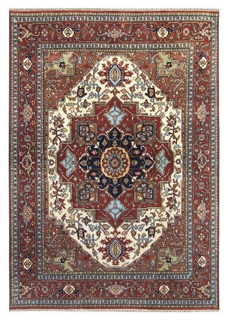 Full overhead view of ivory and rust Serapi wool rug with navy geometric star medallion
