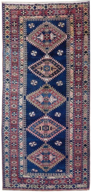 Navy blue antique Kazak rug with five serrated diamond medallions and rust ivory borders