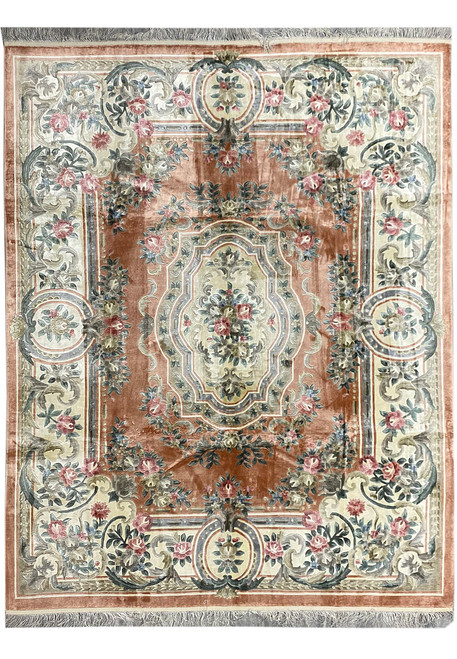 Rust field Aubusson rug with ivory scrolling border, pink rose garlands and shaped floral medallion
