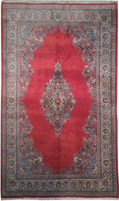 Overhead view of 7'1 x 11'7 Persian Sarough rug with open red field and ivory floral border