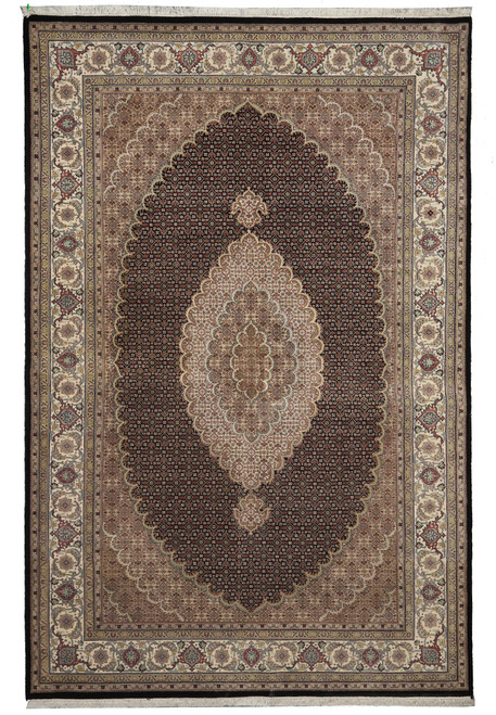 Full flat view of black field Mahi rug with ivory oval medallion and floral border