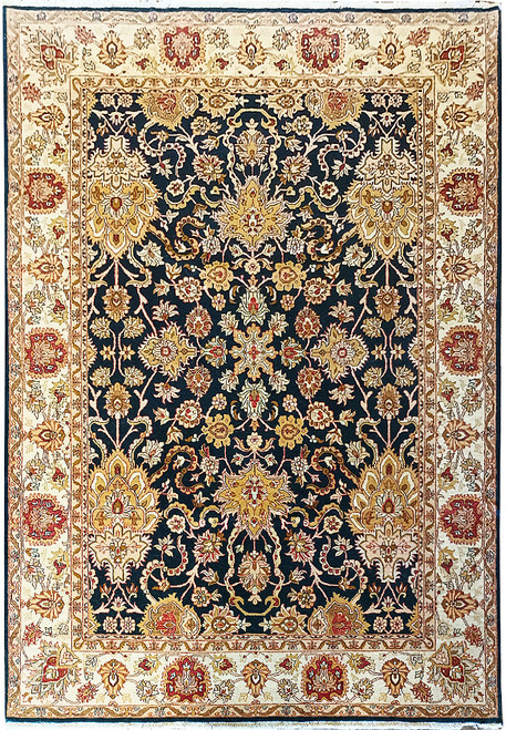 Midnight blue Agra oriental rug with ivory floral border and gold palmettes shown flat overhead