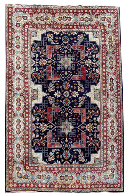 Full overhead view of the navy Sarouk rug with twin red medallions and wide ivory border
