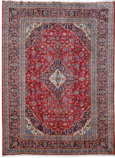 8'4" x 11'8" Persian Kashan rug laid flat showing red floral field and navy border