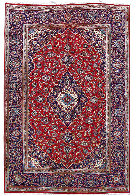 Red Persian Kashan rug with navy floral border and ivory lobed medallion, full overhead view