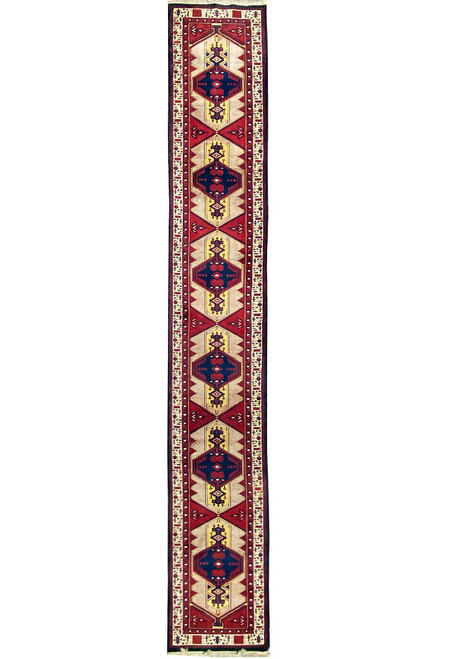 Full overhead view of the long narrow runner, six linked medallions down an ivory and red field