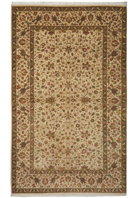 Full overhead view of the ivory Chobi rug with olive green border and pale fringe