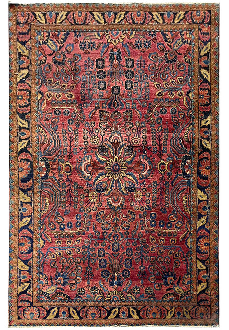 Full overhead view of the red Sarouk rug with navy palmette border and floral field