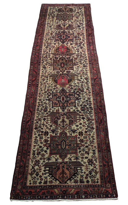 Full view of ivory Persian Karaja runner with a column of alternating geometric medallions