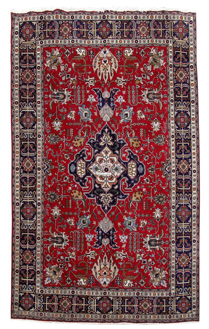 Full overhead view of red Tabriz rug with navy central medallion and ivory and indigo double border