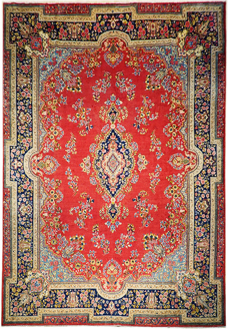 Red Persian Sarouk rug with navy floral border, ivory corner lobes and lobed center medallion