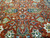 Central field detail showing mirrored navy medallion motifs, cloud band scrolls and green split leaves