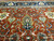 Upper field and navy border meeting, ivory shield palmettes above a symmetrical floral column