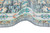 Rolled edge showing low wool pile depth and layered guard stripes of this oversize rug