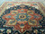 Large 12' x 15' geometric medallion rug photographed from one corner showing full navy field