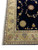 10' x 13' Tabriz rug corner angled to show ivory border scrollwork and navy floral field