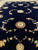 Open midnight blue field photographed from floor level with vine arches and pale gold rosettes