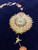 Single large ivory and olive green palmette rosette blooming on the navy blue open field