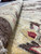 Rolled edge close-up showing dense wool pile, gold border and vegetable dyed burgundy highlights