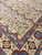 Close corner detail showing burgundy flower chains, blue guard border and lavender lattice arches
