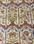 Detail of ivory field flowering plants in green, lavender and apricot under arched vine lattice