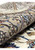Rolled edge of a Persian Isfahan rug showing the dense wool and silk pile and taupe border palmettes
