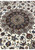 Lobed navy and tan medallion of a 7x10 Persian Isfahan rug seen at an angle in raking light