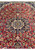 Star medallion of a semi-antique Persian Isfahan rug seen at an angle in raking light