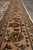 Tan main border seen along its length, palmettes and gold-olive guard stripes beside grey tile